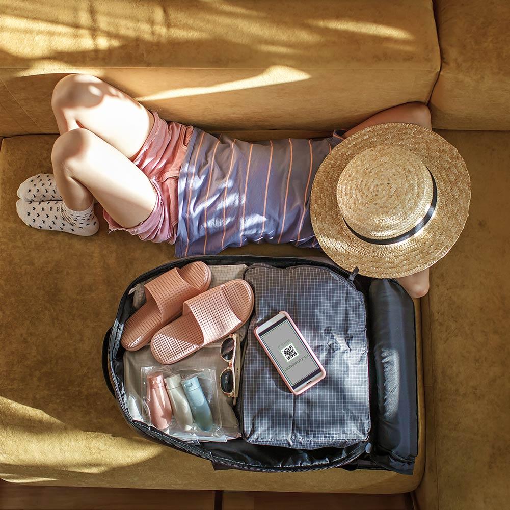 Girl lying next to suitcase