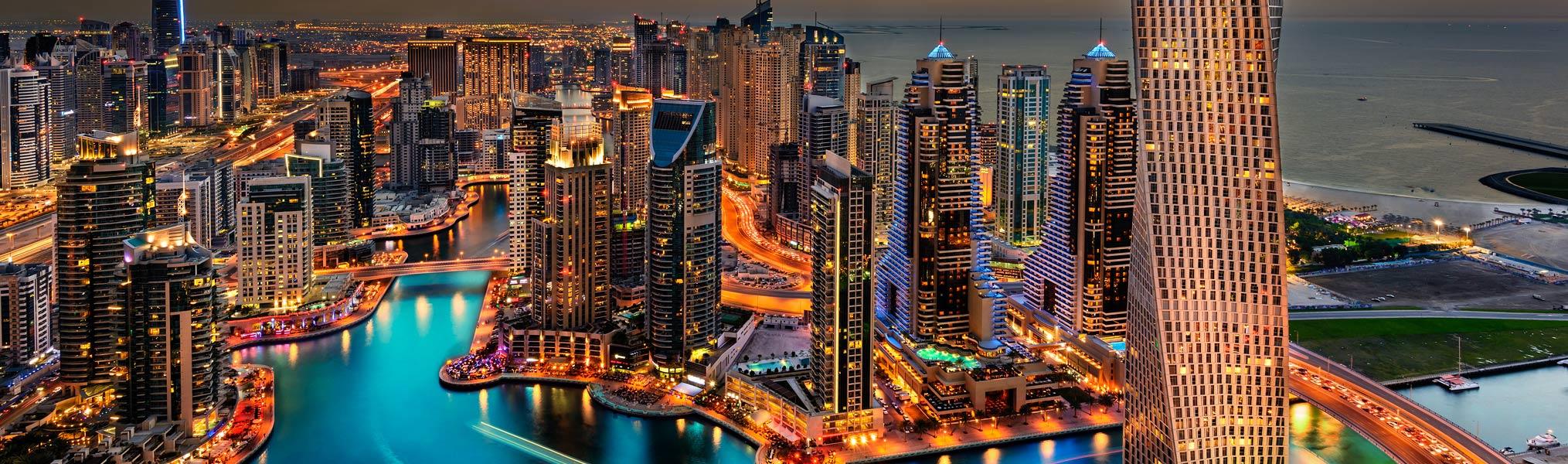 Skyscrapers and city lights along Dubai Marina, a popular UK winter sun getaway.