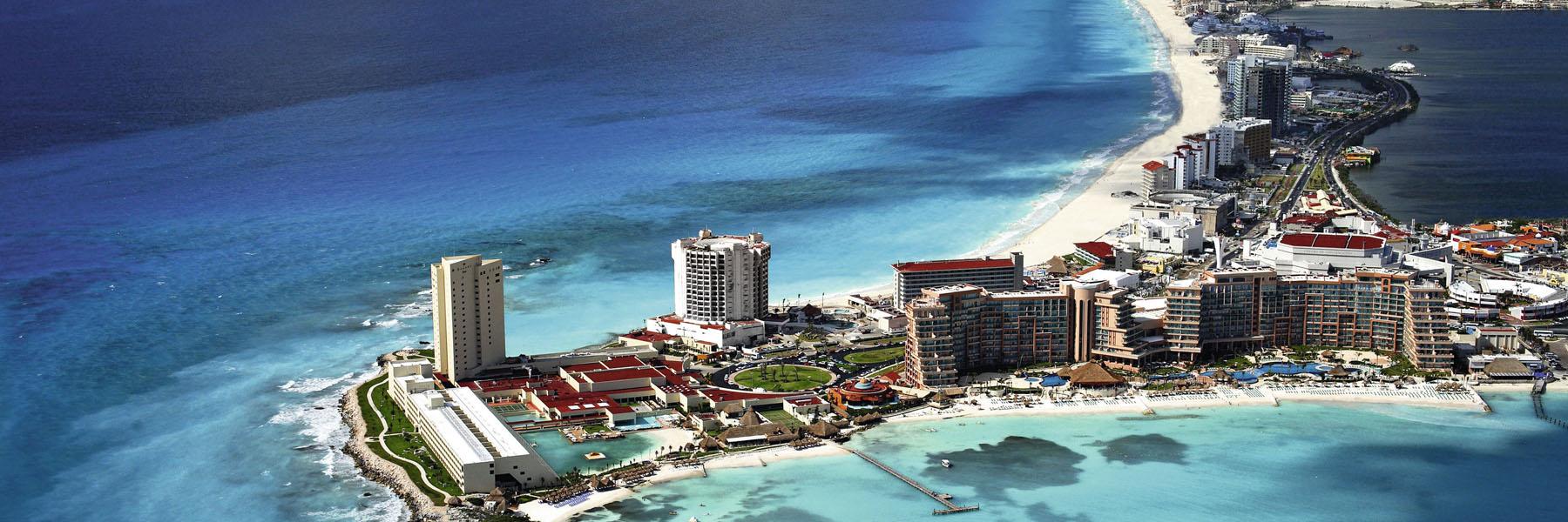 Aerial view of Cancún's hotel strip and Caribbean coastline in Mexico — where to go in August beyond Europe.