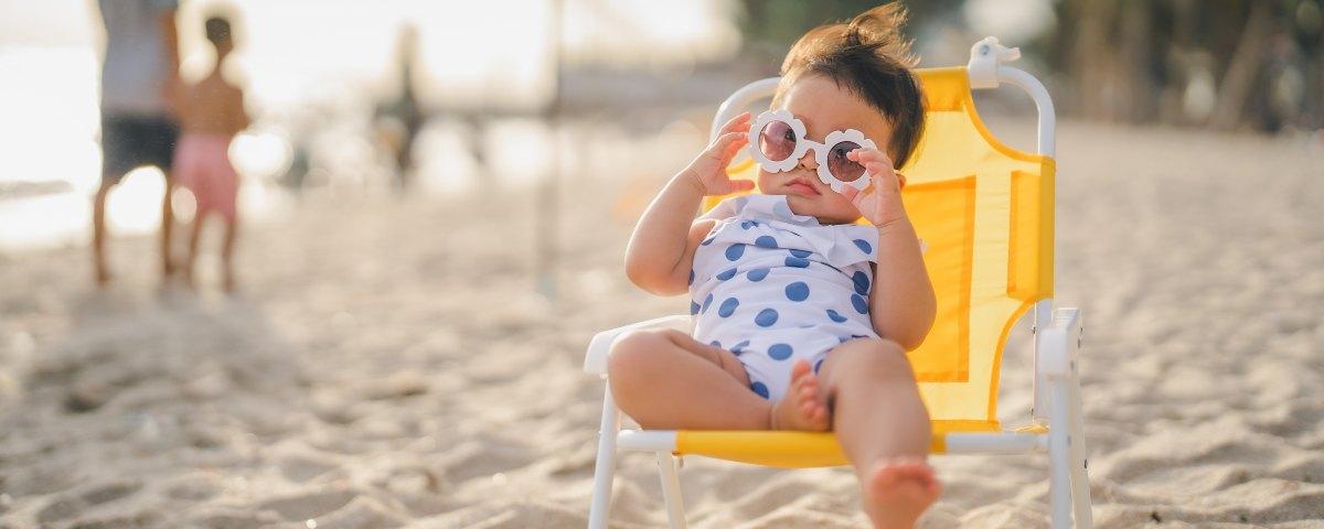 baby relaxing on the beach in chair 