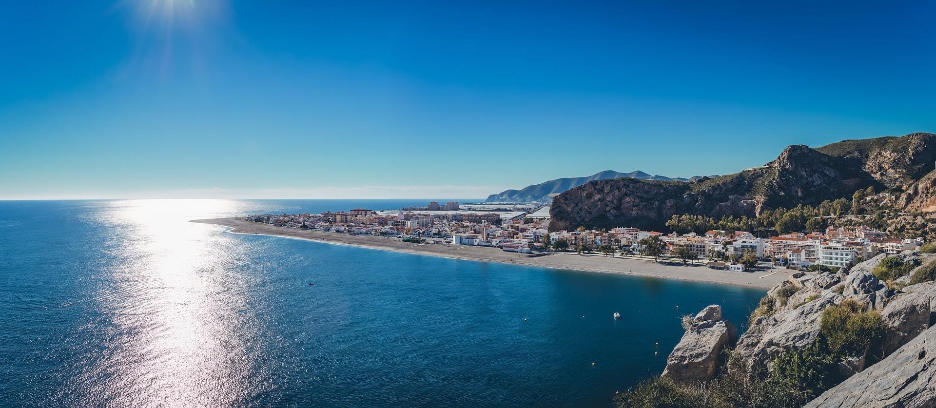 Sun glinting off the sea near a coastal town in Andalusia, southern Spain, a popular UK winter sun getaway.