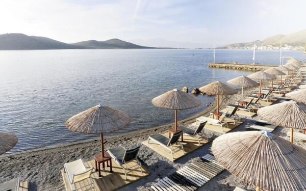 Thomas Cook luxury beachfront resort in Crete with umbrellas, loungers, and sea views for summer 2025 holidays.
