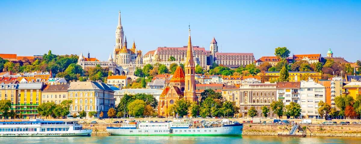 Part of the central Budapest cityscape along the riverfront with tour boats on the water, perfect for a family sightseeing trip.