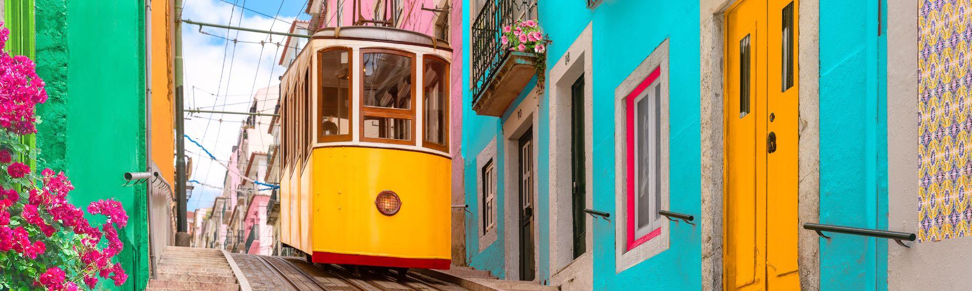 Yellow tram on a colourful street in Lisbon