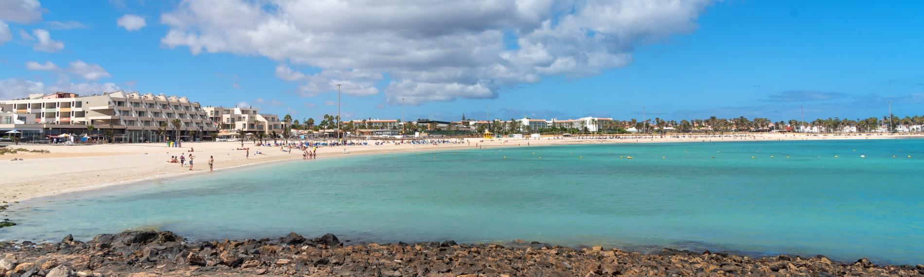 The idyllic white sand and blue sea of popular Caleta de Fuste Beach in Fuerteventura