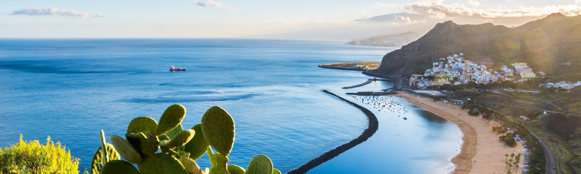 Tenerife beach in mid-September with calm uncrowded shores compared to busy August holiday season.