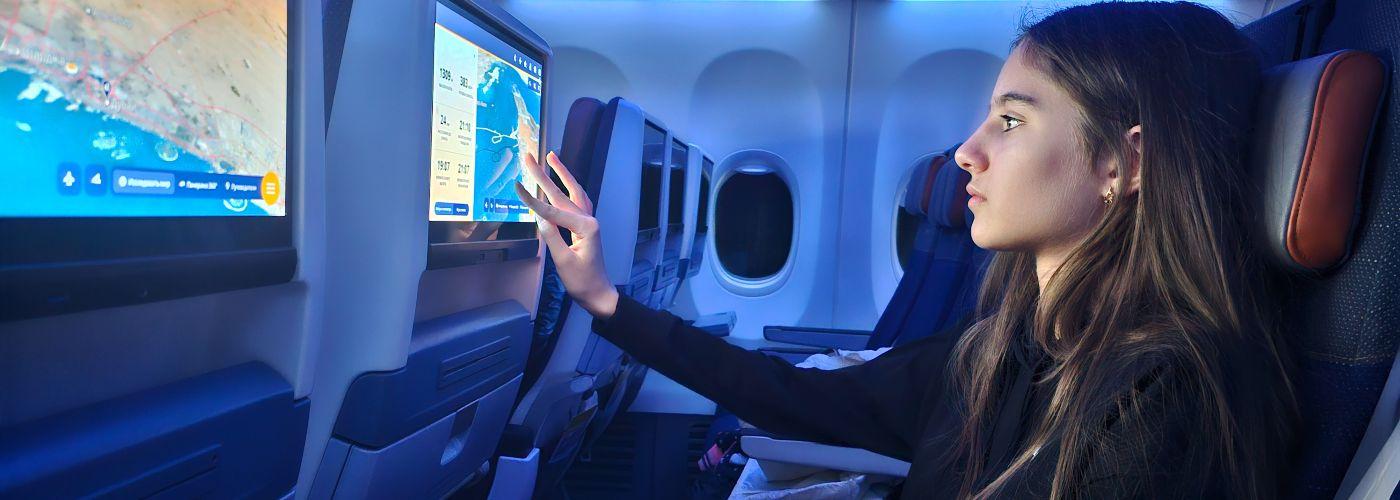 Girl using the in-flight entertainment system