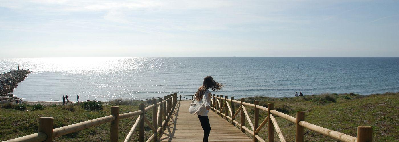 Girl on promenade leading to beach, Costa del Sol