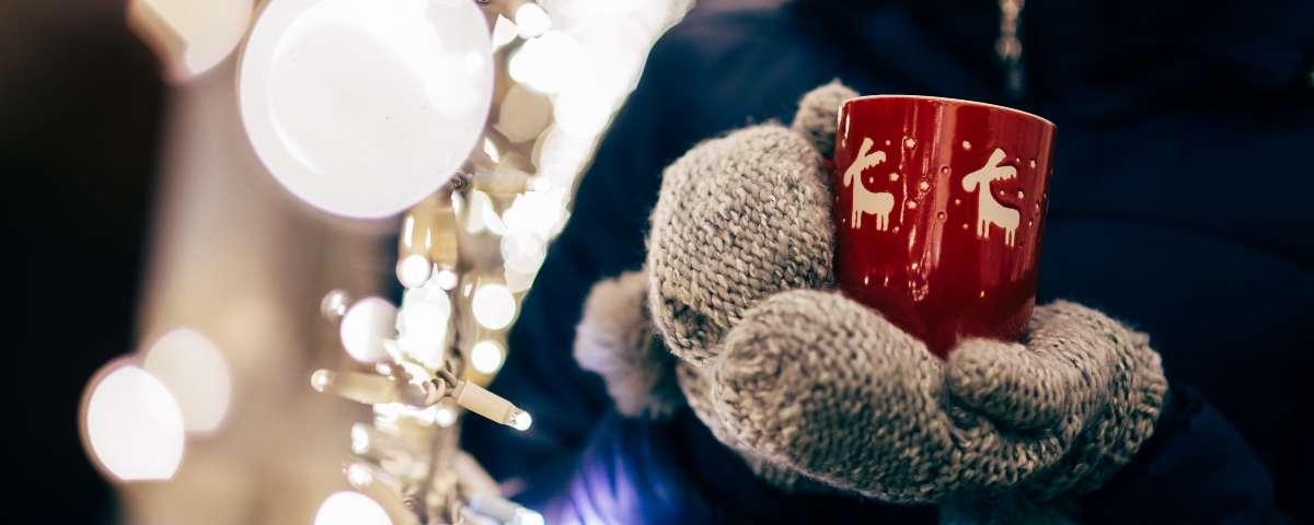 Someone holding a hot mug of chocolate at Christmas time 