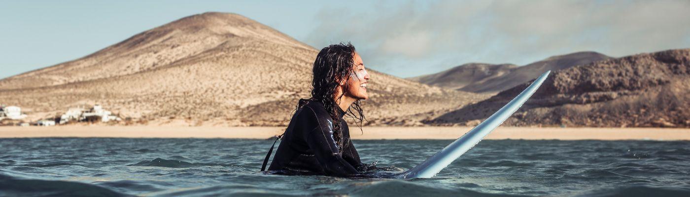 Woman surfing in Fuerteventura