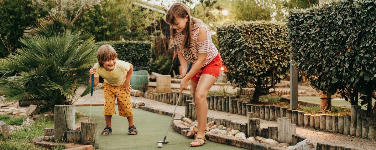 Children playing a game of mini golf