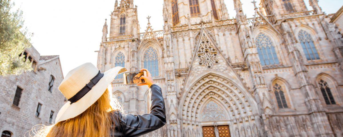 Woman taking photos of the cathedral in Barcelona's picturesque Gothic Quarter
