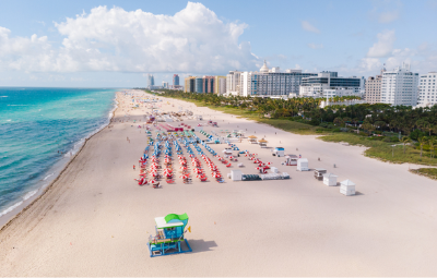 Travellers sunbathing in Miami beach on their summer holidays