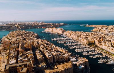 Aerial view of Malta's coastline in October, with warm turquoise seas — Malta holidays.