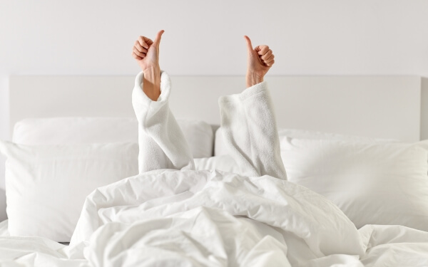 Woman relaxing in bed in a connecting room