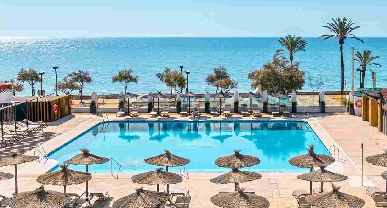 Scenic Greek beach representing Thomas Cook’s strong summer travel season.
