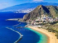 Aerial view of a golden beach and turquoise sea in Tenerife, Canary Islands — a popular October half term 2026 holiday destination.