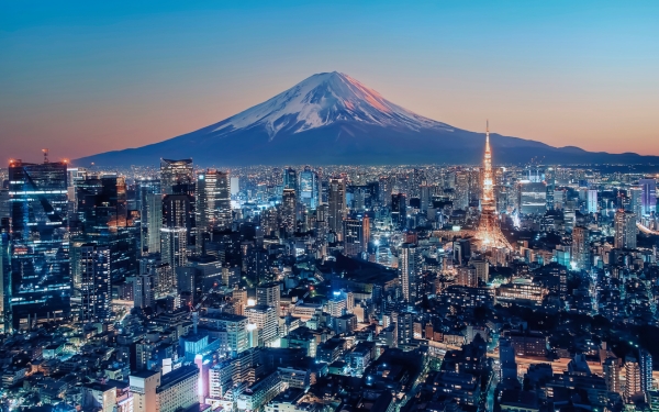 Sunset view of Tokyo city with Mount Fuji in the background, ideal for package holidays.