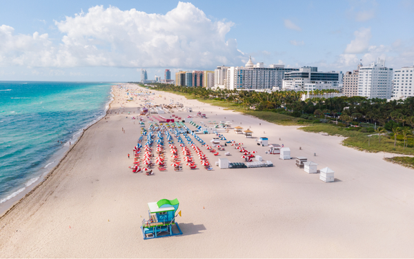 Travellers sunbathing in Miami beach on their summer holidays