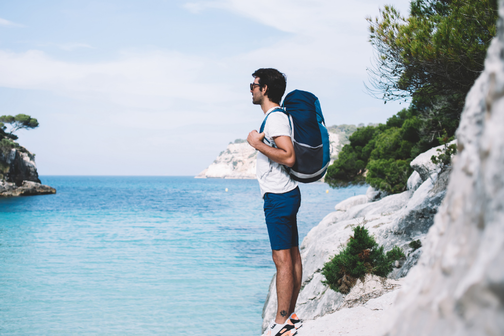 A Man taking in the view of the sea on his solo holiday
