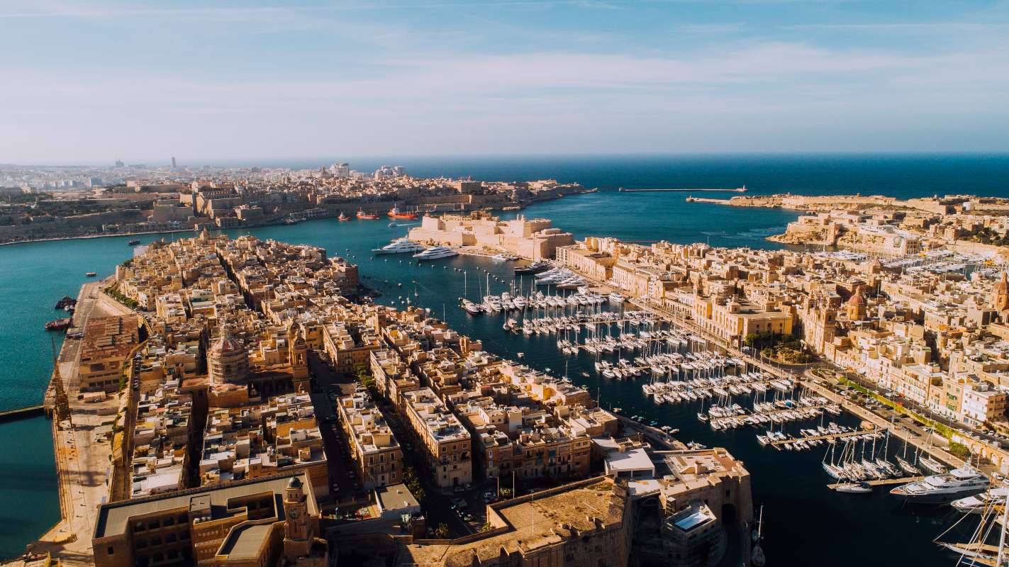 Aerial view of Malta's coastline in October, with warm turquoise seas — Malta holidays.