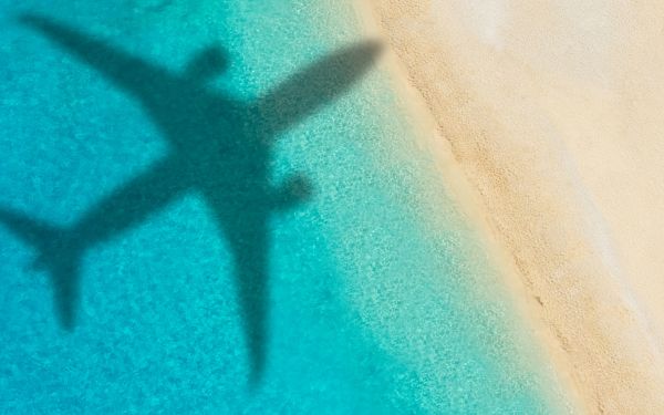 Plane flying over a beach
